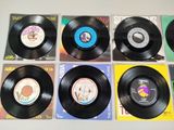 several records are lined up on top of each other on a table