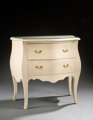 a white chest of drawers with a glass top on a gray surface