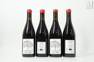 three bottles of wine are lined up on a table