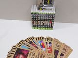 a bunch of books and a pop vinyl figure on a table