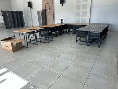 a room with tables and chairs in it and a box on the floor