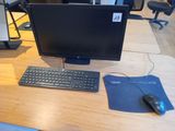 a desktop computer sitting on a desk with a mouse and keyboard