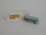 un petit bus miniature posé à côté d'une carte