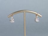 a close up of a pair of earrings on a stand
