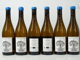 six bottles of wine sitting next to each other on a table