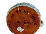 a close up of a vase with writing on it