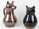 two brown and black vases sitting next to each other