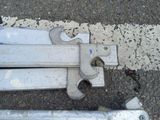 two pieces of metal sitting on the ground next to each other
