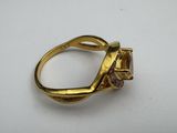 a close up of a gold ring with a diamond on it