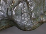 a close up of a bronze statue of a dog