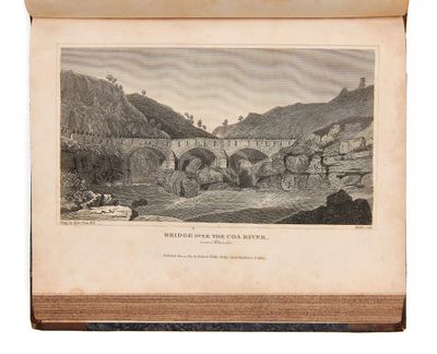 un vieux livre sur lequel figure le dessin d'un pont enjambant une rivière