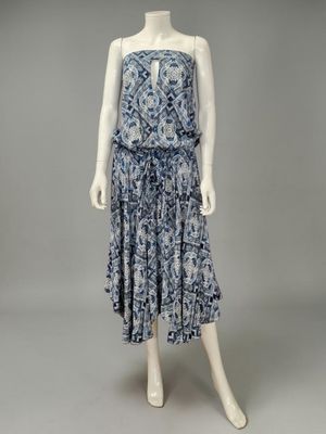 a mannequin wearing a blue and white dress with a floral pattern