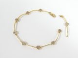a gold and diamond necklace on a white background