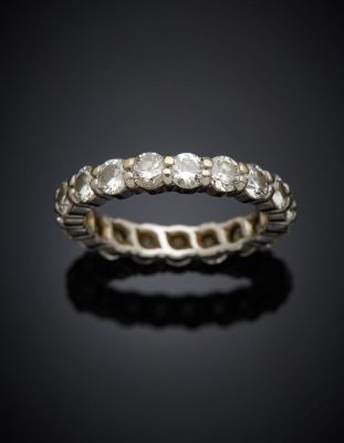 a close up of a diamond ring on a black surface