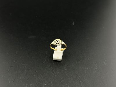 a gold ring with a white stone in the middle of it
