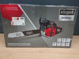 the box of a chainsaw is sitting on a wooden table