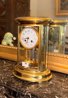 a gold clock sitting on top of a marble counter