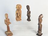 three wooden figurines of different shapes and sizes on a white surface
