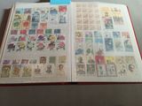 an open book with stamps on it sitting on a table