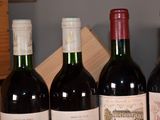several bottles of wine are lined up in a row on a table
