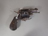 a gun that is on a table with a white background