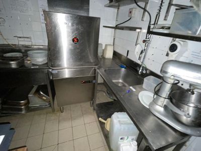 a kitchen with a large stainless steel stove and a sink