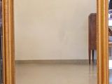 a mirror that is sitting on the floor in front of a table