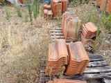 a pile of bricks sitting on a pallet next to a building