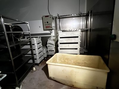 a picture of a kitchen with a large tub in the middle of the room