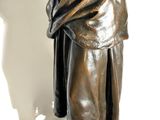 bronze statue of a woman holding a bird in her hand