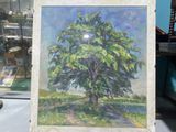 a painting of a tree on display in a glass case