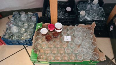many empty plastic cups sitting on the floor next to a box of empty plastic cups
