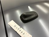 a ruler on the hood of a car next to a car
