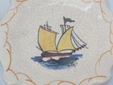 a plate with a picture of a boat on it