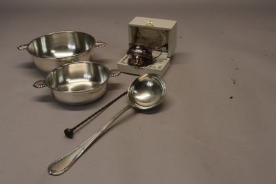three silver bowls and spoons sitting on a table