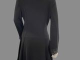 a mannequin wearing a black coat and black pants