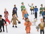 many figurines of people standing together in a circle