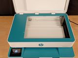 a small printer sitting on a table with a power cord