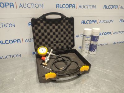 an open case with a pressure gauge and a hose in it