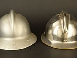 two helmets that are sitting on a table