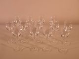 several empty wine glasses are lined up on a white surface