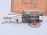 a toy horse pulling a carriage with a man on it