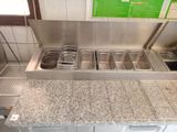 an image of a commercial kitchen with a sink and counter top