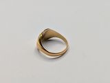 a close up of a gold ring on a white surface