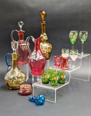 many different colored glass vases and glasses on display