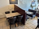 a table and chairs in a restaurant with a chalkboard on the wall