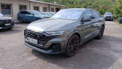 L'Audi Q4 est garée sur un parking, à côté d'autres voitures.