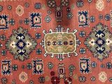 an orange rug with a blue border on a blue background