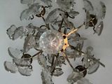 a chandelier made of glass flowers hanging from the ceiling