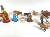 many figurines of people and animals on a white surface